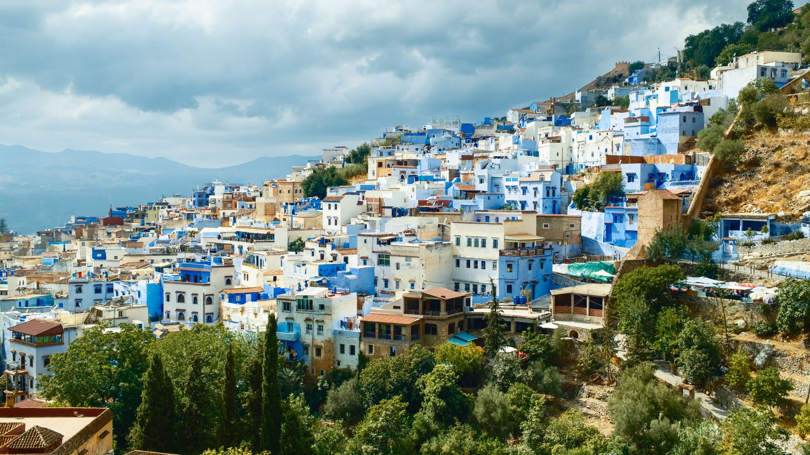 The blue houses of Chefchaouen climbing a hillside below the Rif Mountains