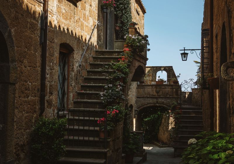 Stone steps and flowers in a Civita di Bagnoregio lane