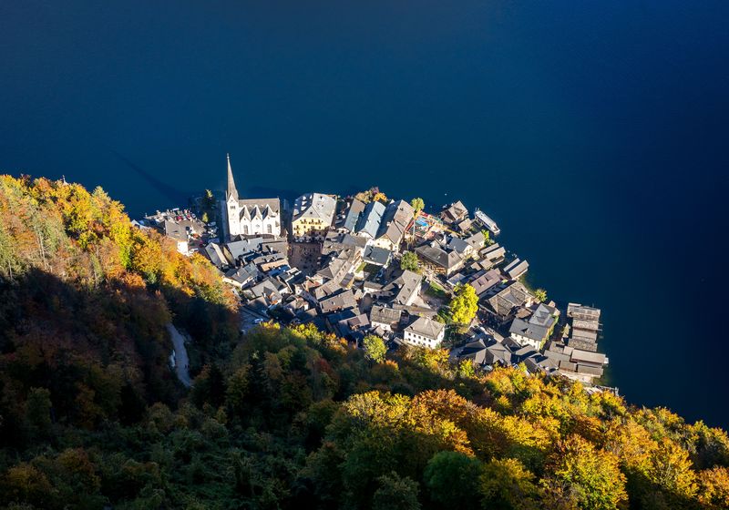 Aerial view of Hallstatt rooftops above the dark lake in autumn