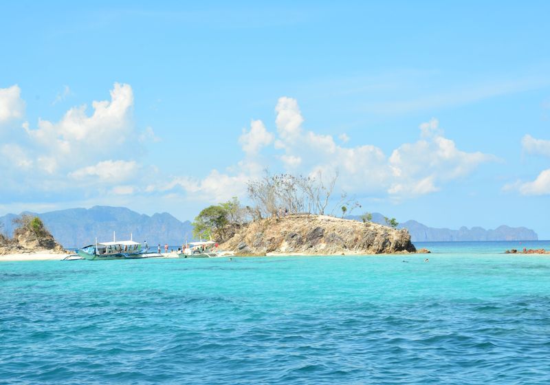 A small rocky island in turquoise water