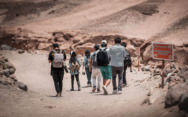 Hikers following a guide along a desert trail